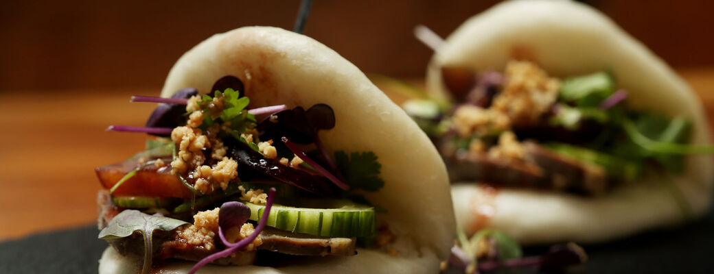 Kačacie gua bao - taiwanská žemľa, konfitovaná trhaná kačka, domáca slivková omáčka, hadia hlava, jarná cibuľka a arašidy